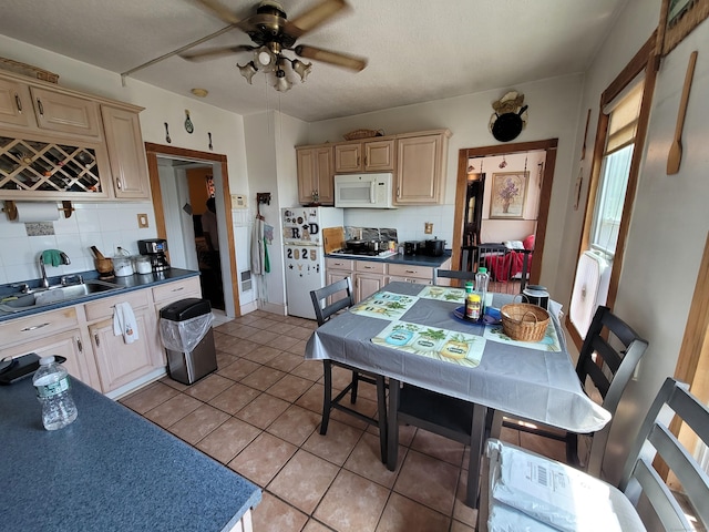 73 Newfield Ave, Bridgeport, CT 06607 - kitchen featuring white appliances, decorative backsplash, dark countertops, and ceiling fan