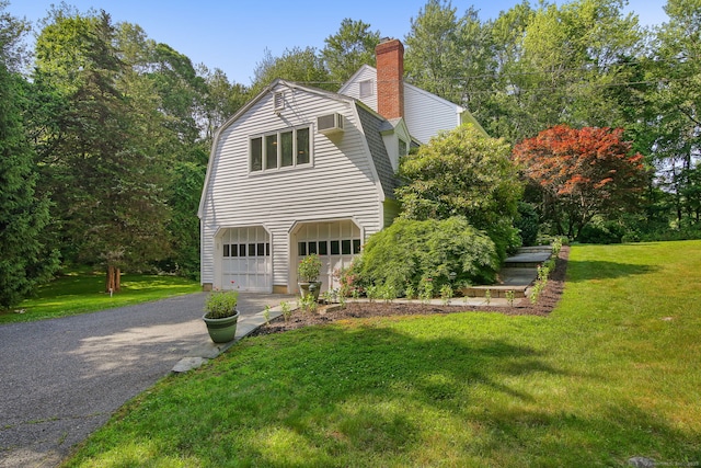 63 Pipers Hill Rd, Wilton, CT 06897 - view of property exterior with driveway, a garage, a lawn, a gambrel roof, and a chimney