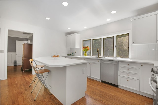 63 Pipers Hill Rd, Wilton, CT 06897 - kitchen with stainless steel dishwasher, a center island, light countertops, range, and recessed lighting