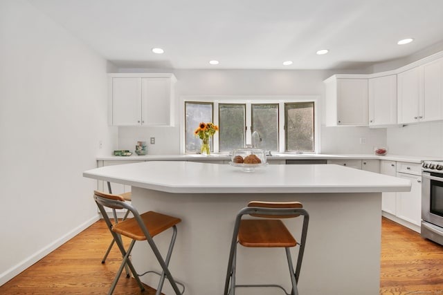 63 Pipers Hill Rd, Wilton, CT 06897 - kitchen with a kitchen bar, tasteful backsplash, electric range, white cabinets, and recessed lighting