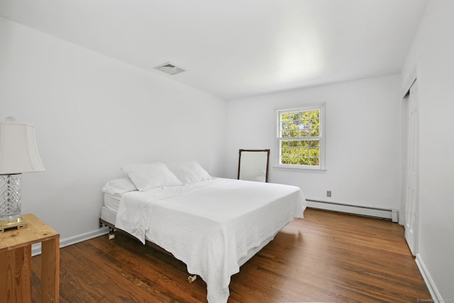 63 Pipers Hill Rd, Wilton, CT 06897 - bedroom with baseboard heating and dark wood-type flooring