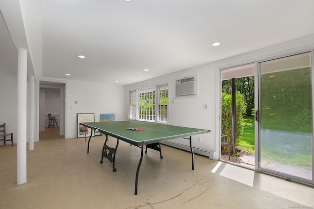 63 Pipers Hill Rd, Wilton, CT 06897 - playroom featuring baseboard heating, a wall unit AC, concrete flooring, and recessed lighting