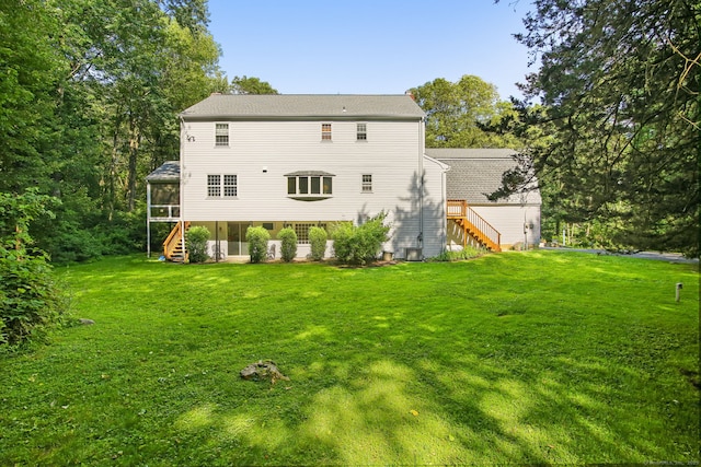 63 Pipers Hill Rd, Wilton, CT 06897 - back of house featuring a sunroom, stairs, and a lawn