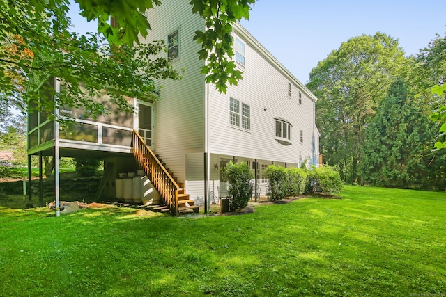 63 Pipers Hill Rd, Wilton, CT 06897 - back of property featuring a sunroom, a lawn, and stairway