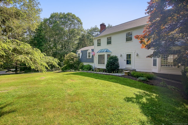 63 Pipers Hill Rd, Wilton, CT 06897 - view of front of house featuring a chimney and a front lawn