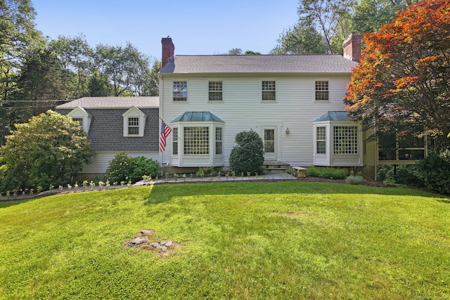 63 Pipers Hill Rd, Wilton, CT 06897 - colonial house with a chimney, a front yard, and roof with shingles