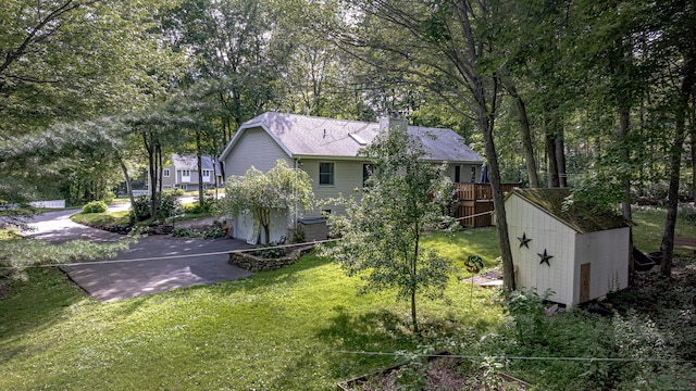 80 Richard Ave, Wolcott, CT 06716 - back of property with a chimney, a garage, and a yard