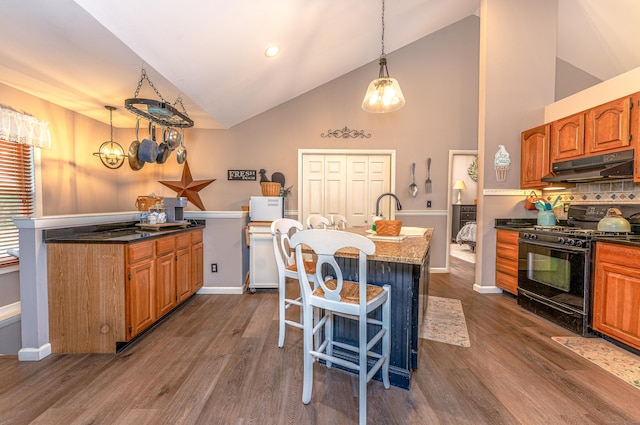 80 Richard Ave, Wolcott, CT 06716 - kitchen featuring under cabinet range hood, black range with gas cooktop, a center island with sink, dark wood-style floors, and brown cabinets