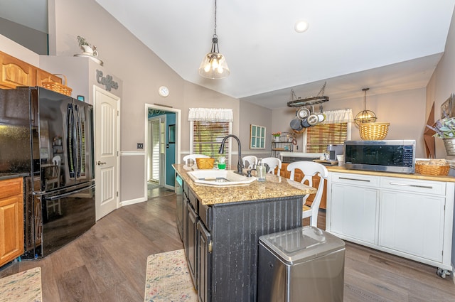 80 Richard Ave, Wolcott, CT 06716 - kitchen with stainless steel microwave, freestanding refrigerator, lofted ceiling, dark wood-type flooring, and an island with sink
