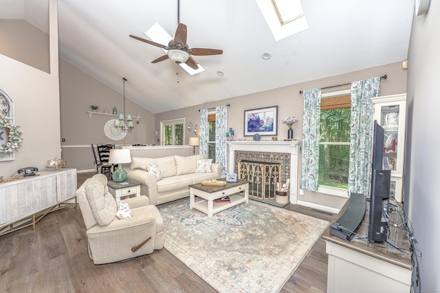 80 Richard Ave, Wolcott, CT 06716 - living room featuring a glass covered fireplace, wood finished floors, a ceiling fan, high vaulted ceiling, and a chandelier