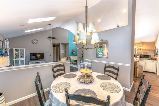 80 Richard Ave, Wolcott, CT 06716 - dining area featuring a skylight, vaulted ceiling, wood finished floors, a chandelier, and a ceiling fan