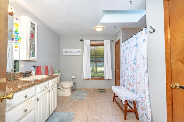 80 Richard Ave, Wolcott, CT 06716 - bathroom with a skylight, vanity, tile patterned flooring, a textured ceiling, and a shower with shower curtain
