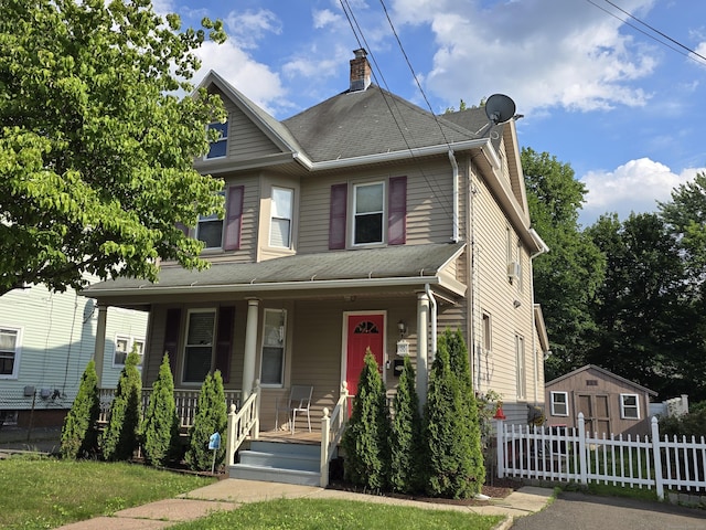 38 Florence St, Manchester, CT 06040 - view of front of house with a porch, a chimney, and a storage unit