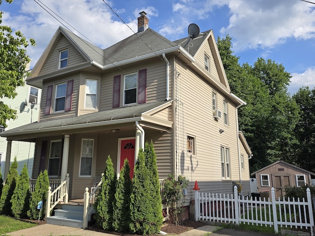 38 Florence St, Manchester, CT 06040 - view of front of house featuring covered porch, an outdoor structure, and a chimney