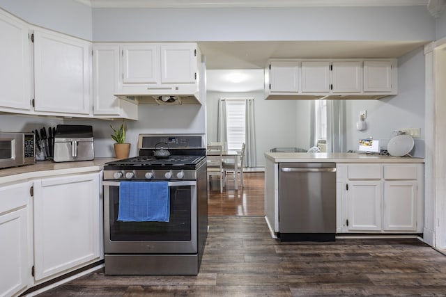 38 Florence St, Manchester, CT 06040 - kitchen featuring appliances with stainless steel finishes, white cabinetry, dark wood finished floors, and under cabinet range hood