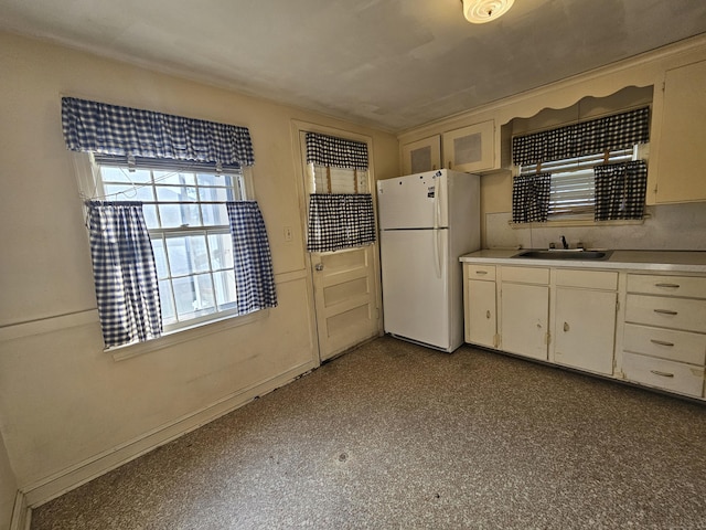 120 Nilan St, Hartford, CT 06106 - kitchen featuring freestanding refrigerator, light countertops, and white cabinetry