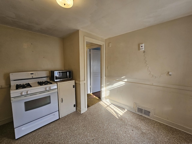 120 Nilan St, Hartford, CT 06106 - kitchen featuring white gas range oven, stainless steel microwave, and white cabinetry
