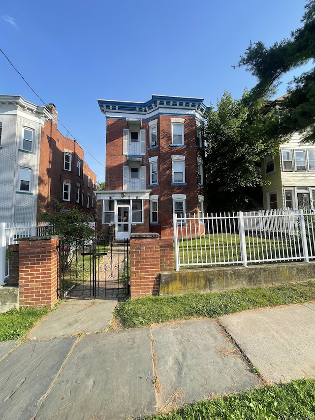117 Shultas Pl, Hartford, CT 06114 - view of front facade with brick siding, a fenced front yard, and a gate