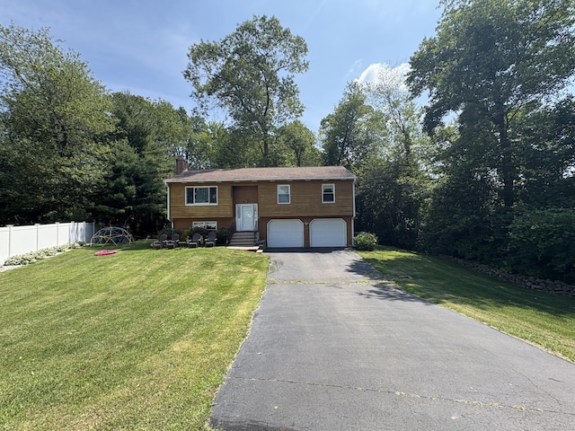 10 Southside Ct, Wallingford, CT 06492 - bi-level home featuring driveway, an attached garage, a chimney, and entry steps