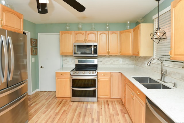 157 Windy Dr, Wolcott, CT 06705 - kitchen with appliances with stainless steel finishes, light brown cabinetry, and a ceiling fan