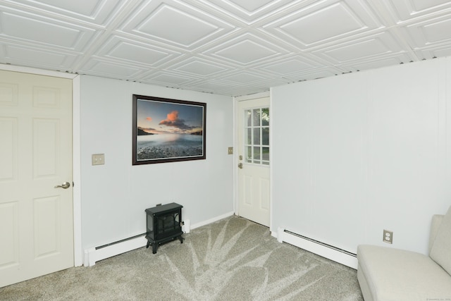 157 Windy Dr, Wolcott, CT 06705 - unfurnished room with baseboard heating, a wood stove, light carpet, and an ornate ceiling