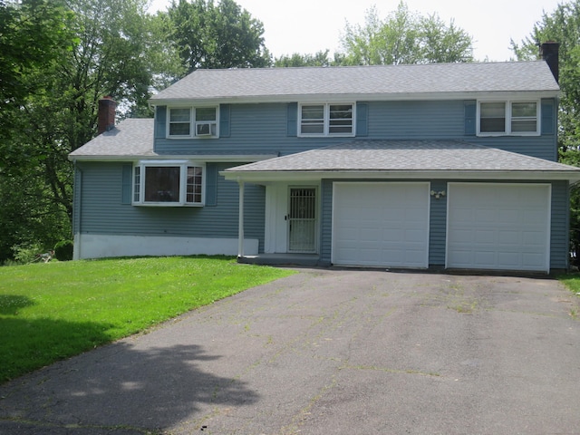 19 Cardston Cir, Windsor, CT 06095 - view of front of house featuring a chimney, driveway, a front lawn, and roof with shingles