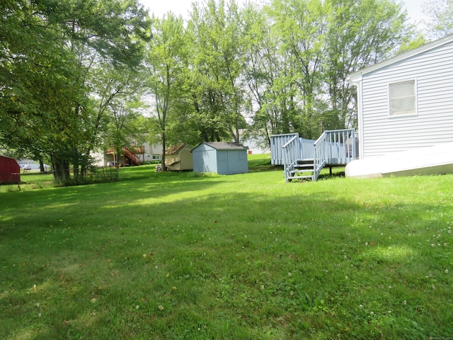 19 Cardston Cir, Windsor, CT 06095 - view of green lawn featuring a storage unit and a wooden deck