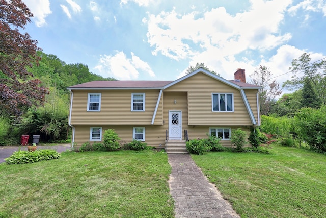 95 Hickory Rd, Naugatuck, CT 06770 - raised ranch featuring a chimney and a front yard