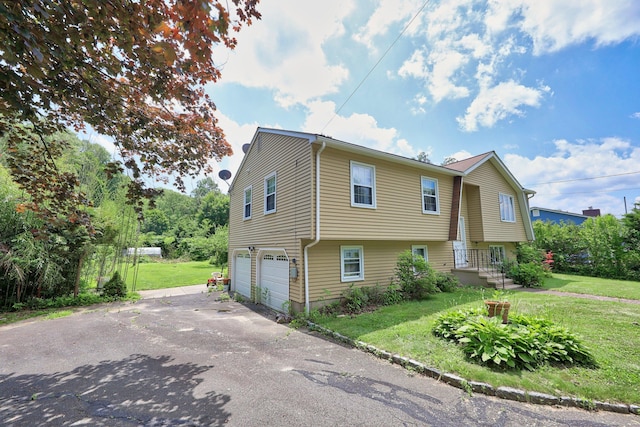 95 Hickory Rd, Naugatuck, CT 06770 - view of property exterior featuring an attached garage, asphalt driveway, and a lawn