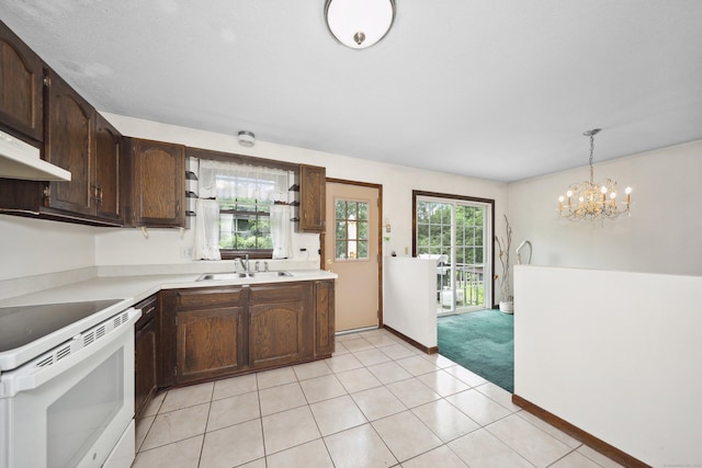 95 Hickory Rd, Naugatuck, CT 06770 - kitchen with white electric range, light countertops, a chandelier, dark brown cabinetry, and hanging light fixtures