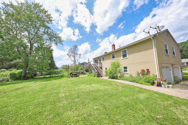 95 Hickory Rd, Naugatuck, CT 06770 - view of green lawn with stairs, an attached garage, and asphalt driveway