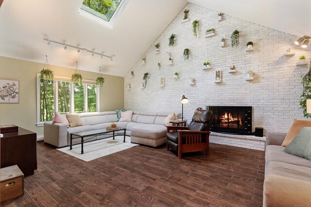19 Pumpkin Hill Rd, Trumbull, CT 06611 - living room featuring rail lighting, brick wall, dark wood-type flooring, a brick fireplace, and high vaulted ceiling