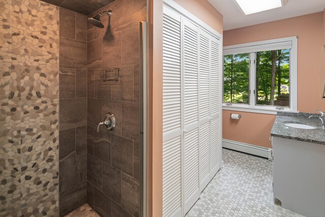 19 Pumpkin Hill Rd, Trumbull, CT 06611 - bathroom with a baseboard heating unit, a tile shower, vanity, and a closet