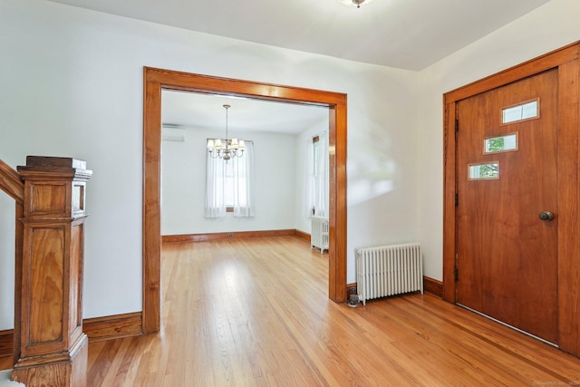 12 Lincoln Ave, Danbury, CT 06810 - entryway with radiator heating unit, light wood-type flooring, a chandelier, and a wall unit AC