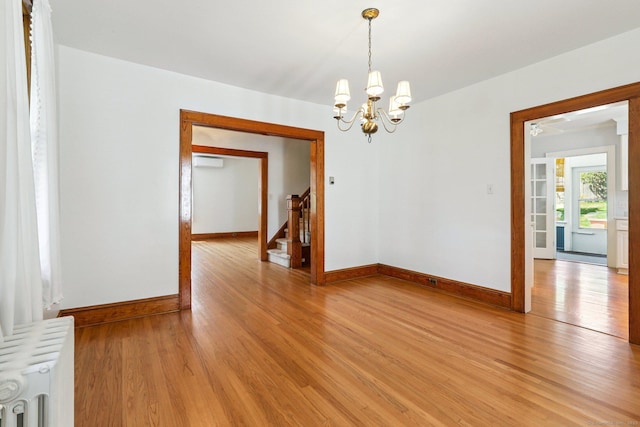 12 Lincoln Ave, Danbury, CT 06810 - unfurnished room with radiator heating unit, light wood finished floors, a chandelier, and stairway