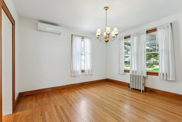 12 Lincoln Ave, Danbury, CT 06810 - spare room with radiator, a wall unit AC, light wood-style flooring, and a chandelier