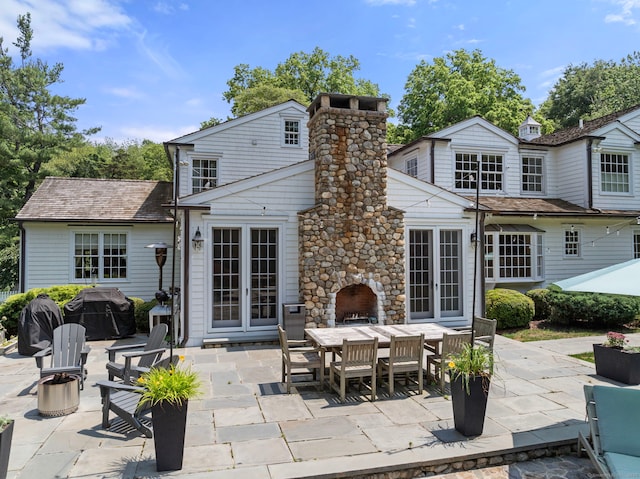 92 Hornbeam Rd, Fairfield, CT 06824 - back of house featuring a patio area, outdoor dining space, and a chimney
