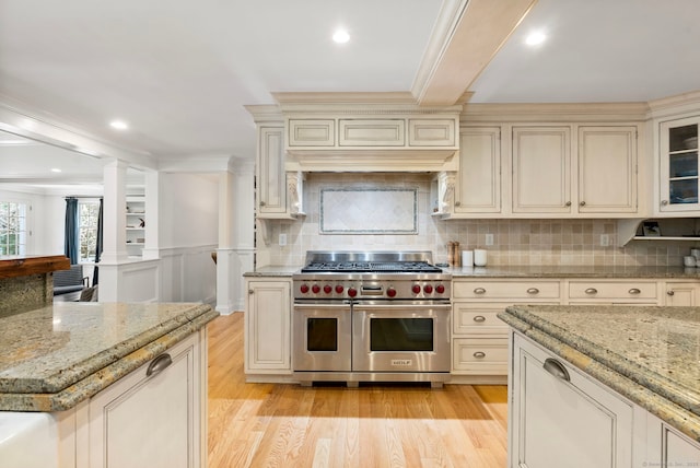 92 Hornbeam Rd, Fairfield, CT 06824 - kitchen with double oven range, cream cabinets, light wood-type flooring, decorative backsplash, and ornamental molding