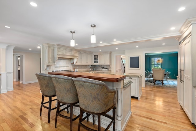 92 Hornbeam Rd, Fairfield, CT 06824 - kitchen featuring a breakfast bar, crown molding, tasteful backsplash, recessed lighting, and light wood-style flooring