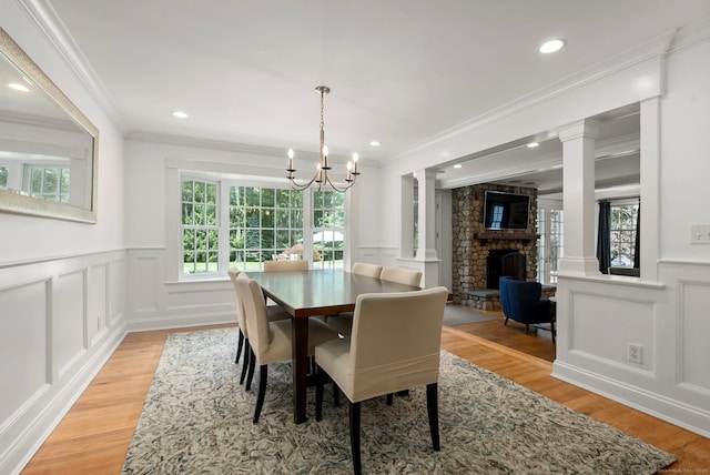 92 Hornbeam Rd, Fairfield, CT 06824 - dining space featuring a decorative wall, healthy amount of natural light, light wood-type flooring, decorative columns, and a chandelier