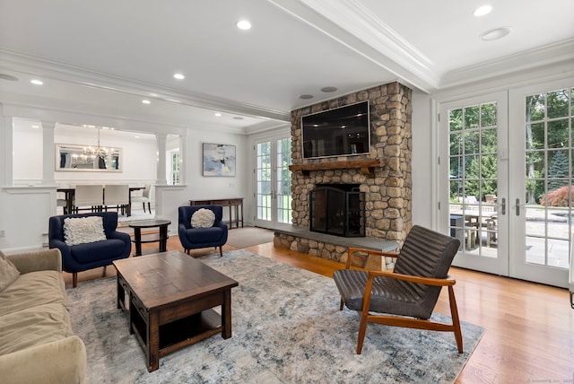 92 Hornbeam Rd, Fairfield, CT 06824 - living area with ornamental molding, plenty of natural light, a chandelier, light wood-type flooring, and french doors