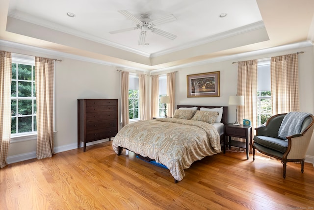 92 Hornbeam Rd, Fairfield, CT 06824 - bedroom featuring a tray ceiling, multiple windows, crown molding, and light wood-type flooring