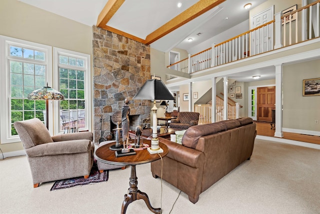 95 Cedar Swamp Rd, Chester, CT 06412 - living area featuring a stone fireplace, high vaulted ceiling, ornate columns, beam ceiling, and carpet floors