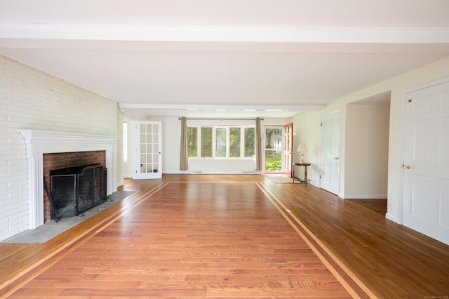 117 Long Meadow Hill Rd, Brookfield, CT 06804 - unfurnished living room featuring a brick fireplace, light wood-style floors, and brick wall