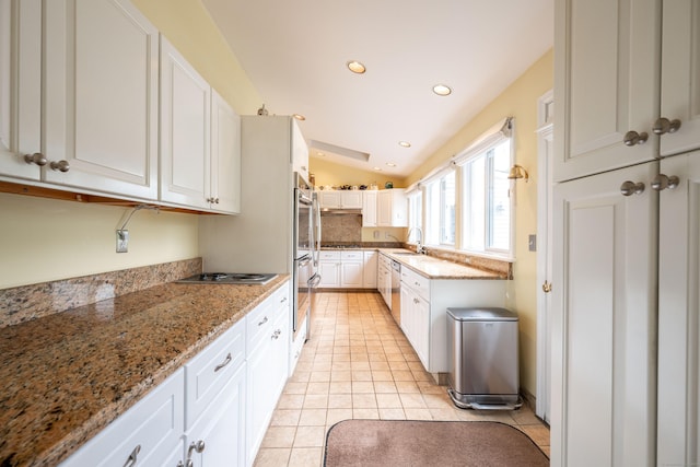 117 Long Meadow Hill Rd, Brookfield, CT 06804 - kitchen featuring white cabinetry, lofted ceiling, light tile patterned floors, stainless steel appliances, and light stone countertops