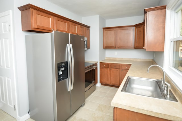 129 Tomlinson Ave, Plainville, CT 06062 - kitchen featuring appliances with stainless steel finishes, light countertops, and brown cabinets