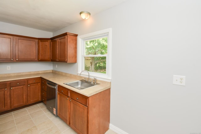 129 Tomlinson Ave, Plainville, CT 06062 - kitchen with stainless steel dishwasher, brown cabinets, light countertops, and light tile patterned floors