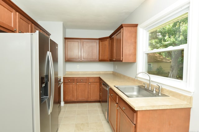 129 Tomlinson Ave, Plainville, CT 06062 - kitchen with stainless steel appliances, light countertops, brown cabinets, and light tile patterned flooring