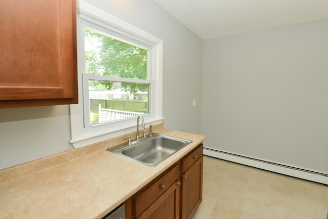 129 Tomlinson Ave, Plainville, CT 06062 - kitchen with baseboard heating, light countertops, and brown cabinetry