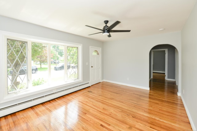 129 Tomlinson Ave, Plainville, CT 06062 - unfurnished room featuring a baseboard heating unit, plenty of natural light, arched walkways, and a baseboard radiator
